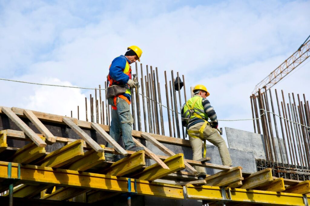 workers examining work for construction resource management