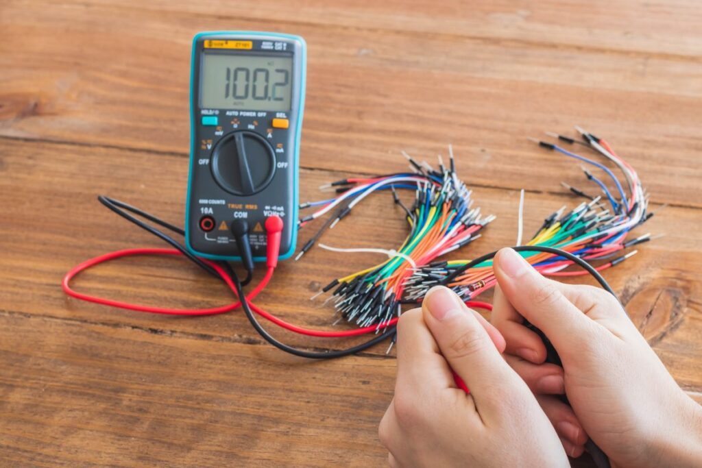 closeup shot digital multimeter with many colorful wires wooden table Short Circuit Calculations